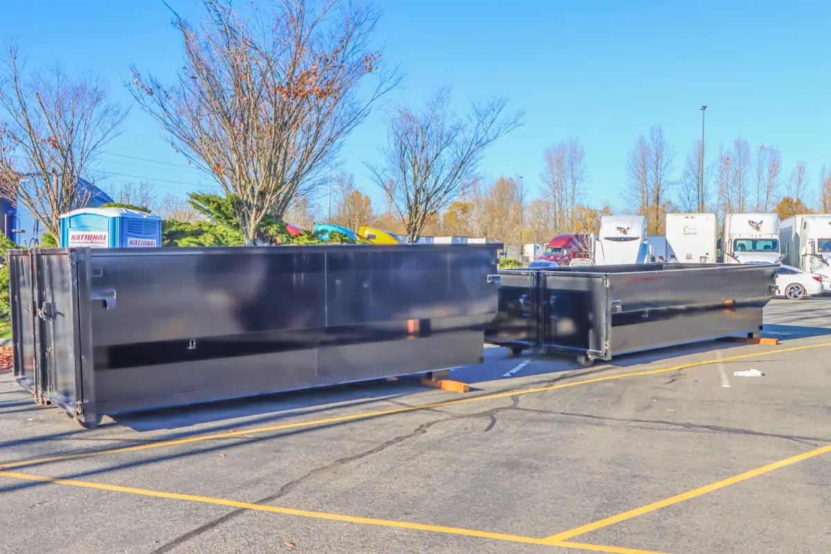 Professional dumpster rental service with roll-off container on residential driveway in San Mateo